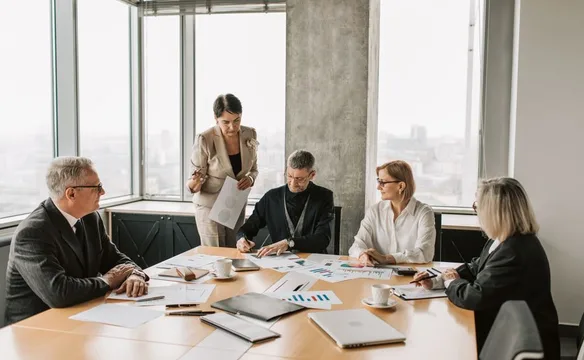 Executives reviewing documents in a meeting